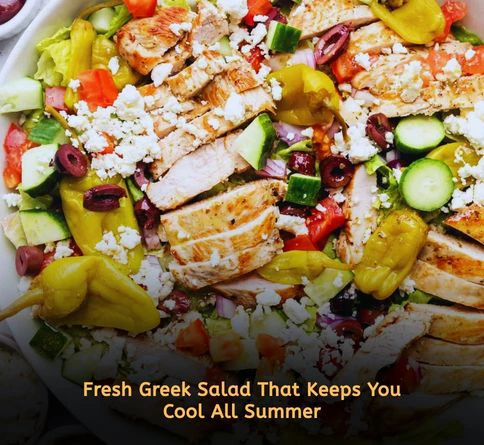 Fresh Greek chicken salad with cucumbers, cherry tomatoes, feta cheese, and grilled chicken in a white bowl for healthy summer lunch ideas