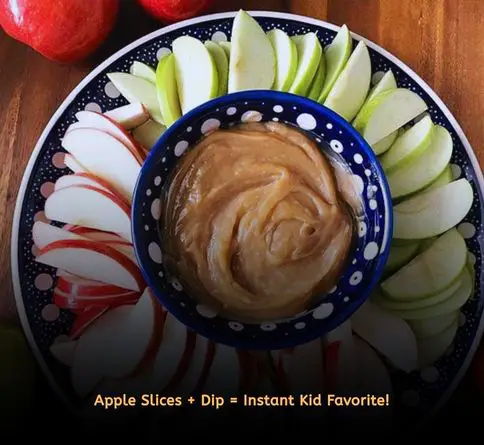 Apple slices with peanut butter dip for healthy kids picnic snack.