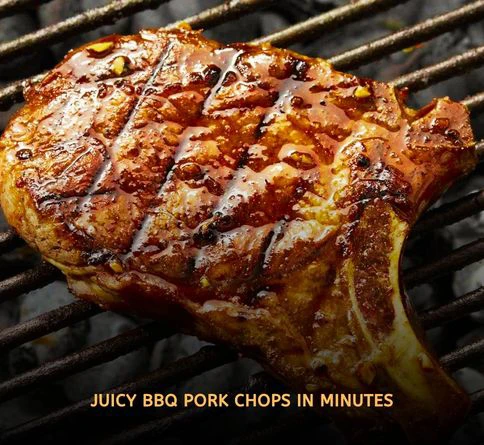 Thick BBQ glazed pork chops grilling with smoky caramelized sauce on an outdoor summer barbecue grill.