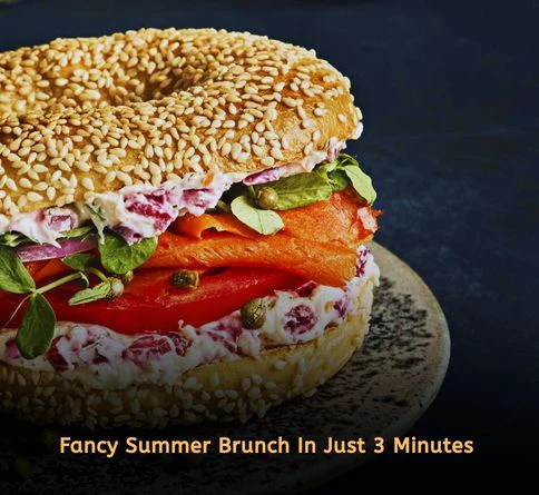 Bagel topped with cream cheese, smoked salmon, capers, and red onion slices for brunch