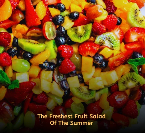 Colorful tropical fruit salad with pineapple mango kiwi and honey lime dressing in a large bowl