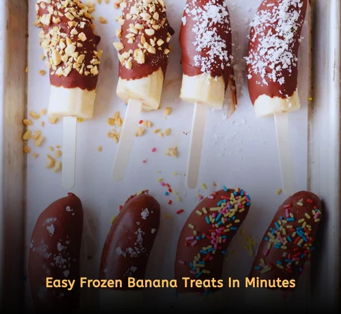 Chocolate dipped frozen banana slices coated with crushed graham crackers on a tray
