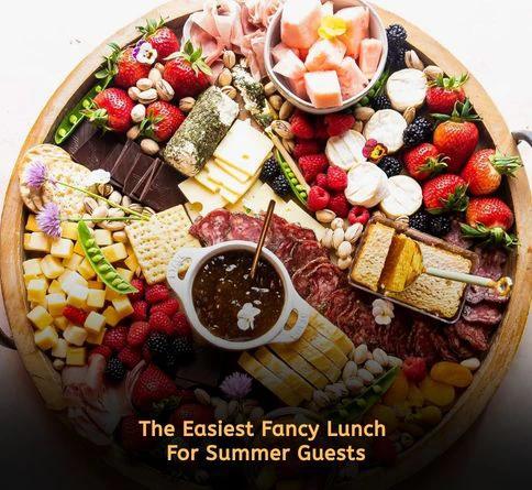Elegant summer charcuterie board with cheese crackers grapes almonds and prosciutto for adult lunch gatherings