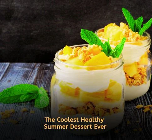 Summer fruit parfait layered with yogurt, berries, granola, and honey in a glass