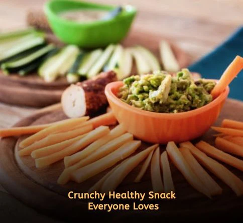 Fresh carrot sticks served with creamy homemade guacamole dip for healthy family snacking