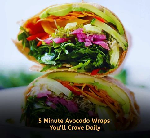 Creamy avocado veggie wraps filled with spinach and carrots on a wooden board for easy summer lunch ideas