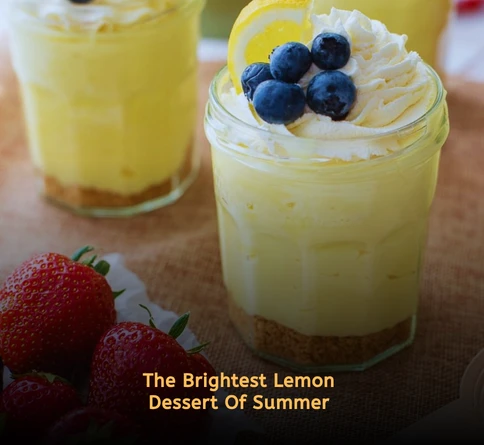 Layered lemon parfait with yogurt lemon curd granola and fresh lemon zest in a clear dessert glass