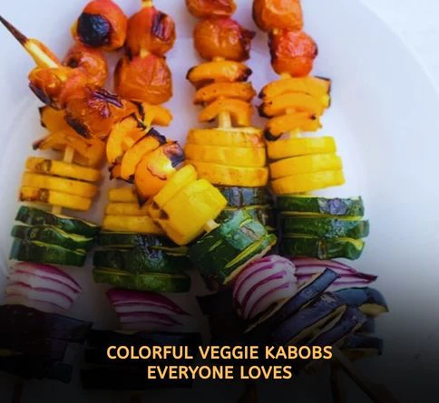 Rainbow vegetable kabobs with bell peppers zucchini and onions grilling on barbecue grate