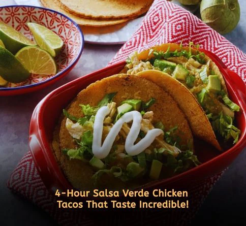 Slow cooker salsa verde chicken tacos topped with cilantro and onions on warm tortillas.