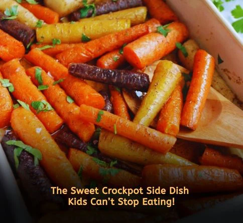 Honey garlic glazed baby carrots in a crockpot with buttery sauce and fresh parsley garnish.