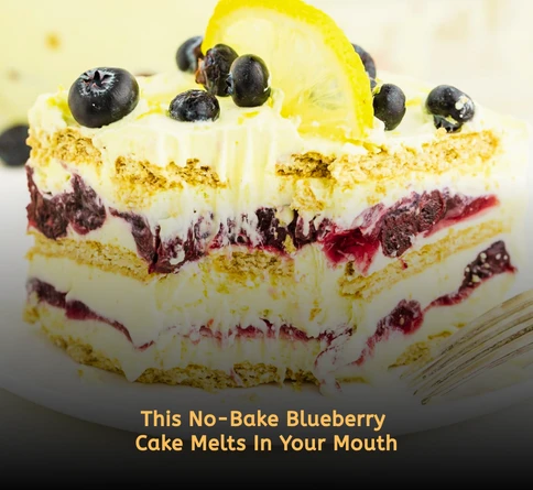 Layered blueberry icebox cake with whipped cream graham crackers and fresh blueberries in a glass dish