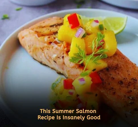 Grilled salmon fillet topped with fresh mango salsa for a healthy summer dinner