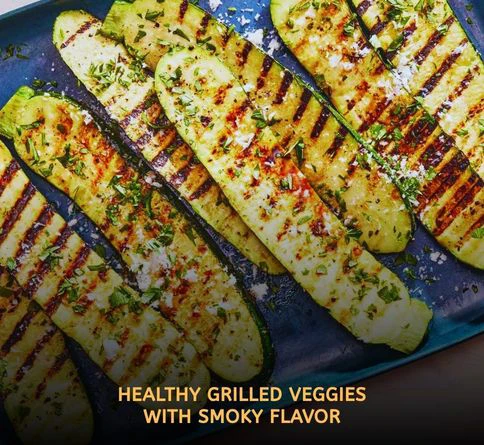 Fresh grilled zucchini and yellow squash slices with smoky grill marks served on a summer barbecue platter outdoors.