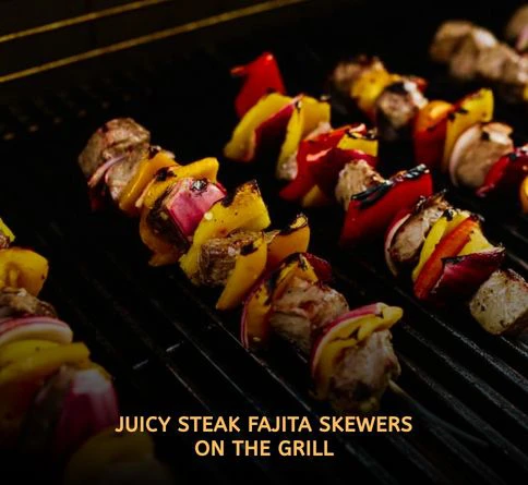 Sizzling steak fajita skewers with bell peppers grilling over high heat during a smoky summer outdoor barbecue.