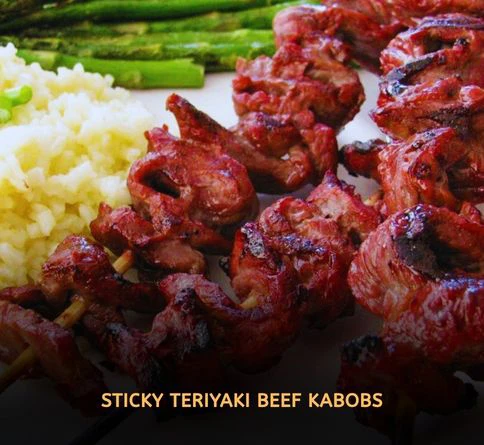 Sweet teriyaki beef skewers glazed and grilled with sesame seeds and green onions