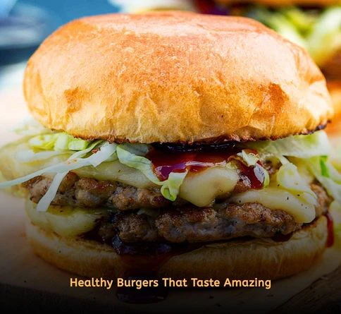 Grilled turkey burgers served with lettuce wraps and tomato slices on a plate.