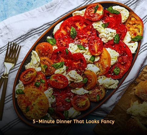 Caprese salad with fresh mozzarella, tomatoes, basil leaves, and balsamic glaze.