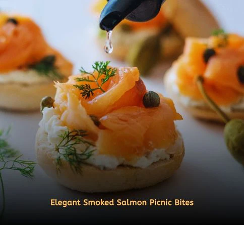 Smoked salmon appetizers topped with cream cheese and fresh dill on dark bread squares.