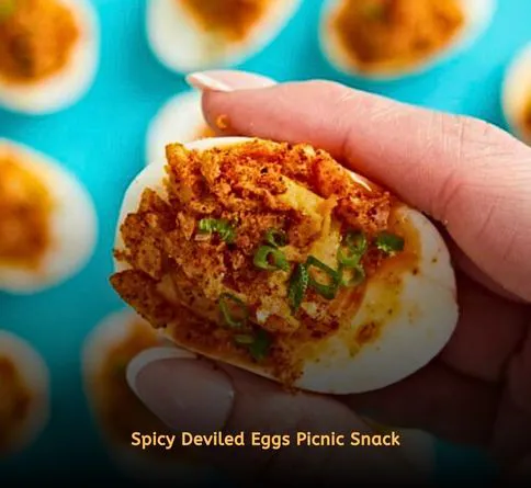 Deviled eggs topped with paprika in picnic tray
