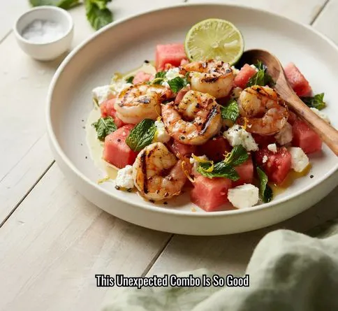 Watermelon feta salad topped with grilled shrimp for a healthy summer dinner.
