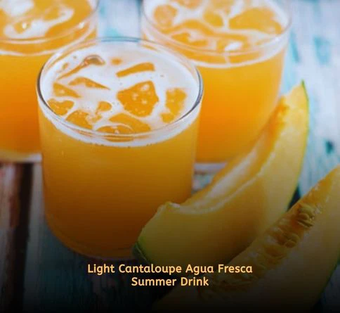 Orange cantaloupe agua fresca in glass with ice
