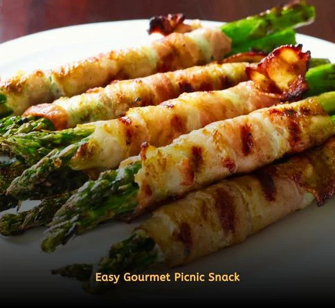 Bacon-wrapped asparagus roasted until crispy and packed for a picnic.