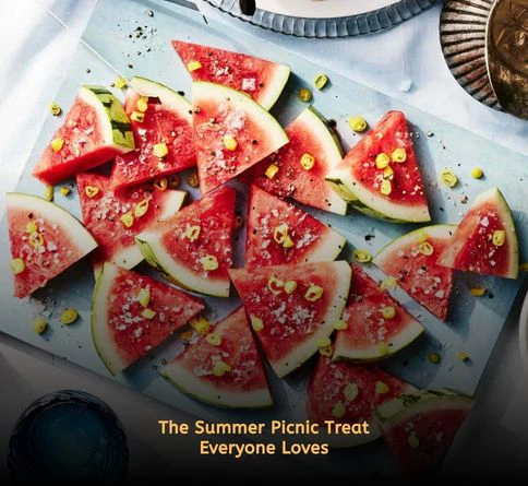 Fresh watermelon wedges chilled in a container on a sunny picnic day