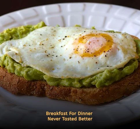 Avocado toast topped with fried eggs and seasoning for a quick summer meal.