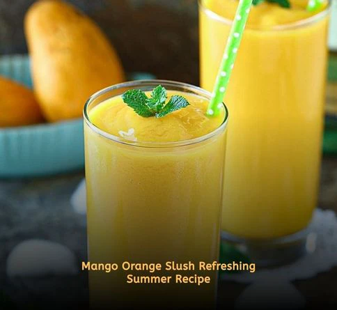 Mango orange slush drink in glass with fruit garnish