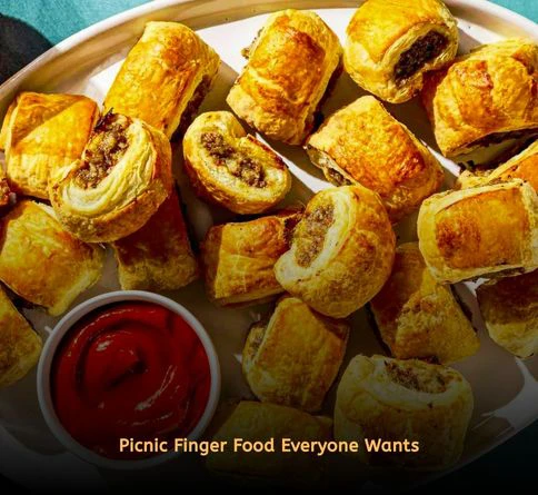 Golden sausage rolls sliced into bite-sized pieces for outdoor entertaining.