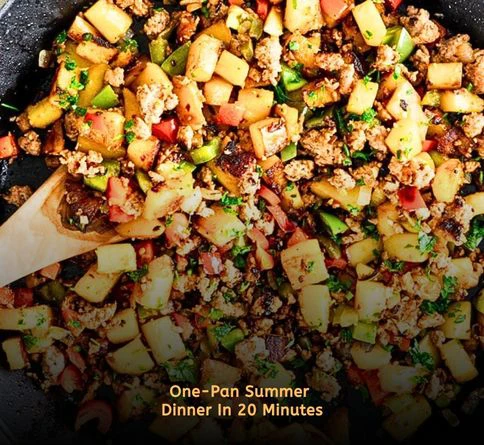 Chicken sausage and colorful bell peppers cooked together in a skillet.