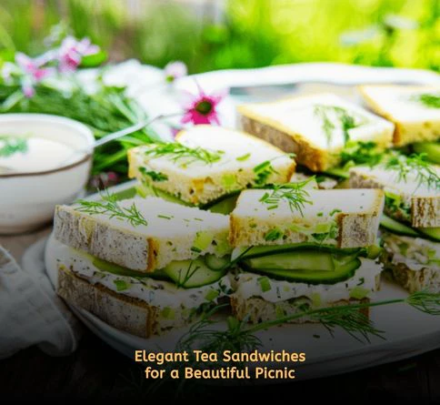Delicate cucumber tea sandwiches cut into triangles and displayed on vintage picnic plates.