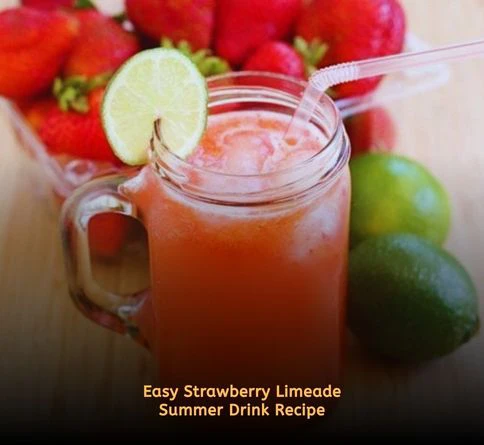 Pink strawberry limeade in glass pitcher with fresh strawberries and ice