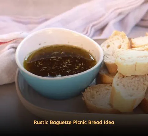 French baguette with olive oil dipping bowl picnic setup