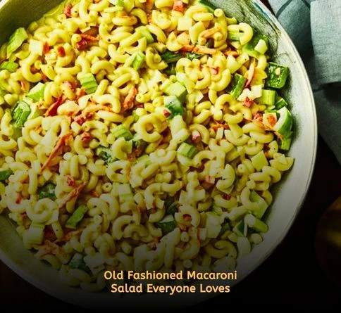 Traditional macaroni salad with colorful vegetables served in a picnic bowl