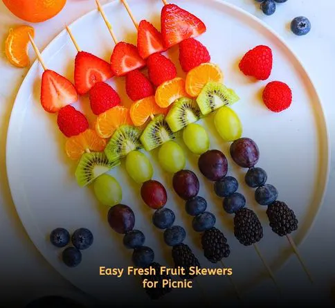 Colorful fruit skewers with strawberries and melon on picnic table