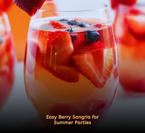 Glass pitcher of berry sangria with strawberries blueberries and orange slices