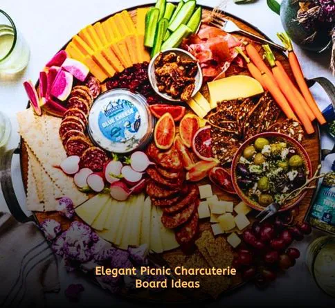 Cheese and crackers charcuterie board laid on picnic blanket
