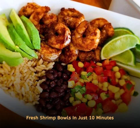 Shrimp and avocado rice bowls topped with fresh lime for a quick summer seafood dinner.