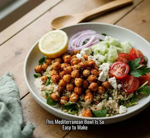 Mediterranean chickpea and veggie bowl with feta and lemon tahini dressing.