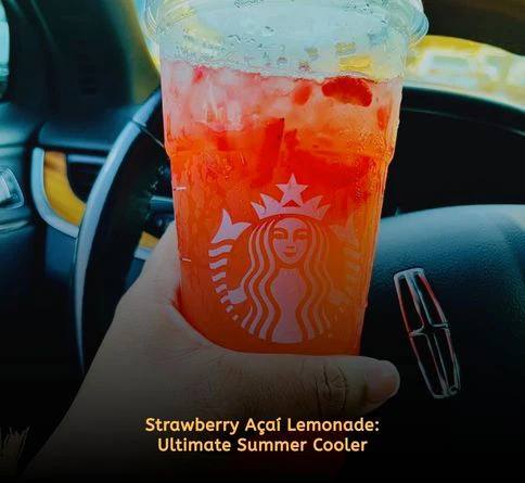 Strawberry Acai Lemonade Refresher with fresh strawberries, lemonade, ice cubes, and vibrant pink-red color