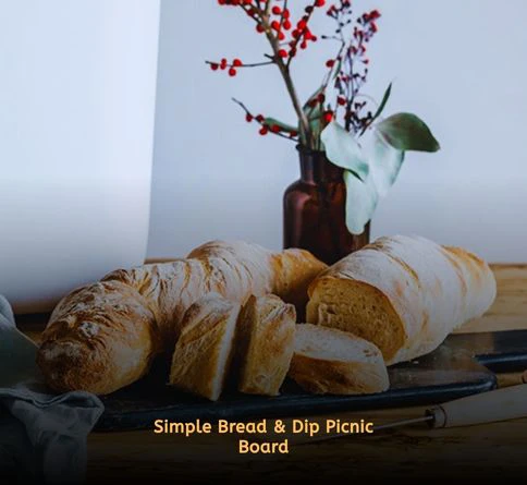 Artisan bread slices served with hummus, yogurt dip, and feta dip for an aesthetic picnic setup.