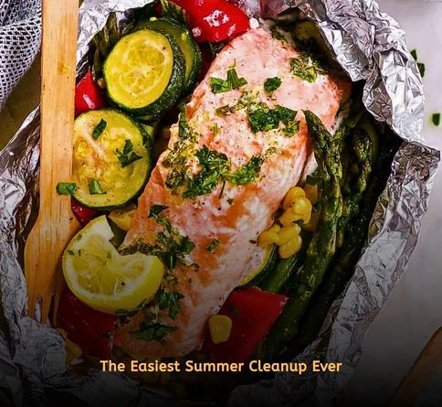 Grilled salmon and broccoli cooked in foil packets with fresh lemon slices.