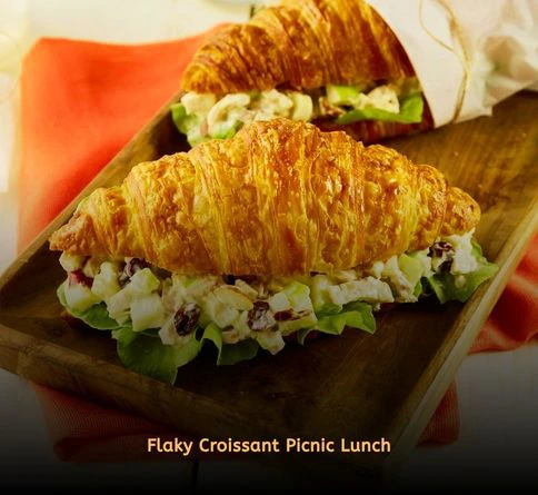 Chicken salad croissants filled with cranberries and pecans for a romantic picnic.