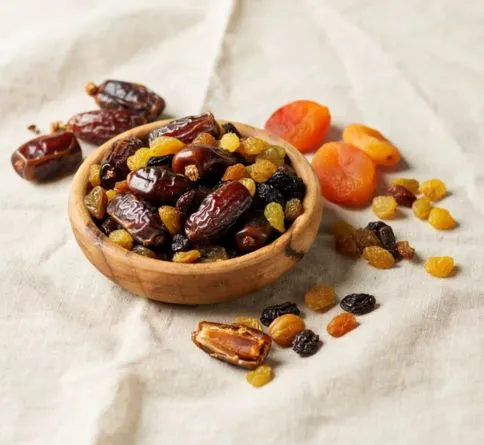 Dried Fruit (Dates, Raisins, Apricots) Bowl of dried dates, raisins, and apricots for quick pre-workout energy