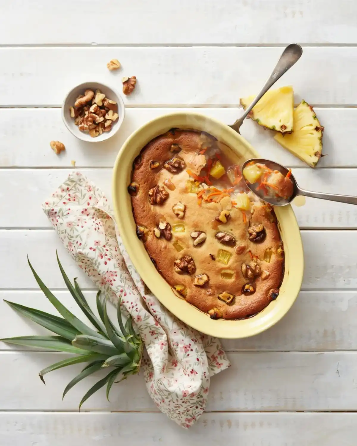 Pineapple walnut carrot cake cobbler topped with toasted walnuts and fresh pineapple pieces.