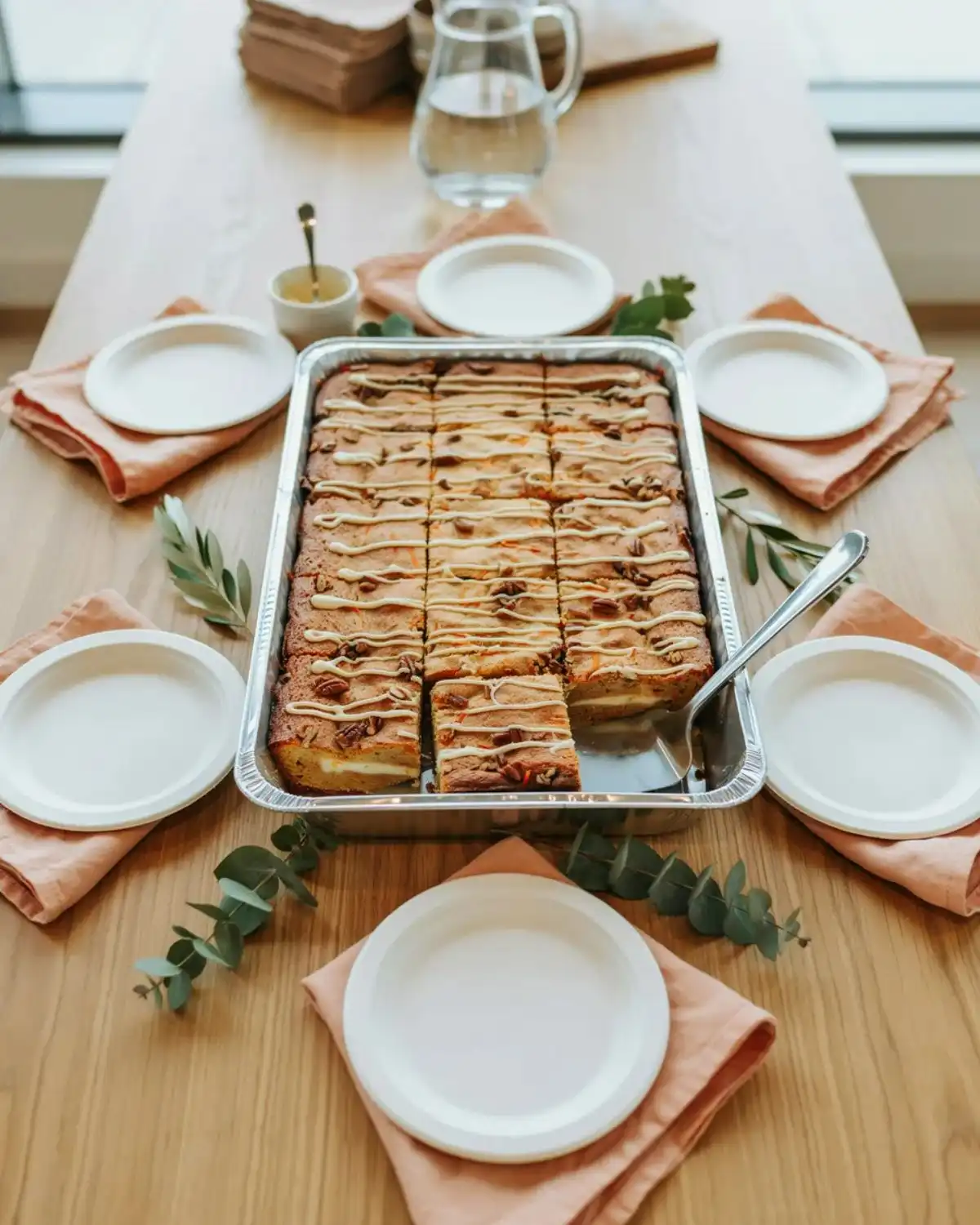 Carrot cake sheet cake cobbler baked in a wide pan and cut into easy crowd-size portions.