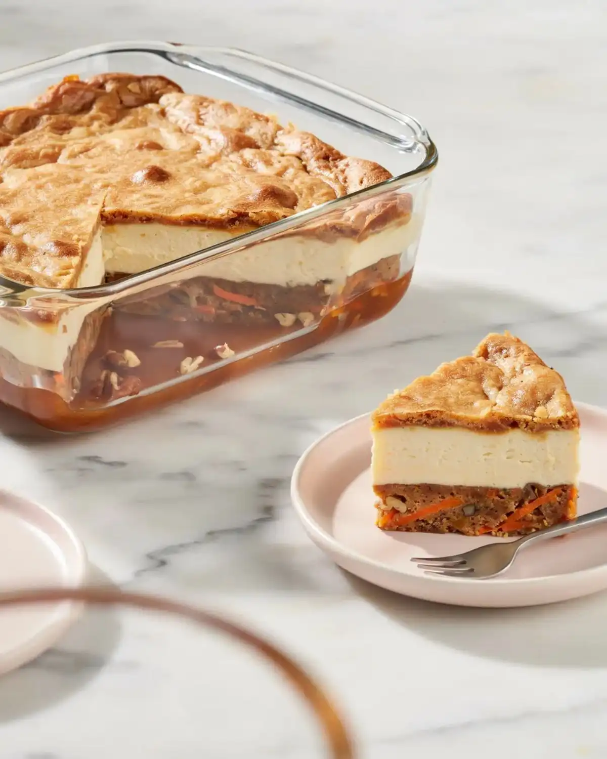 Layered carrot cheesecake cobbler with creamy cheesecake filling and brown sugar sauce.