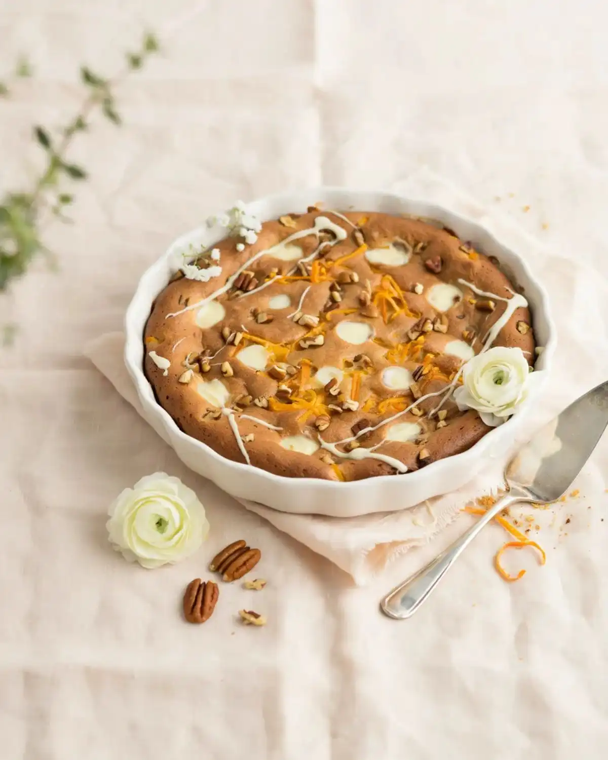 White chocolate carrot cake cobbler with melted white chocolate pieces and a creamy vanilla finish.
