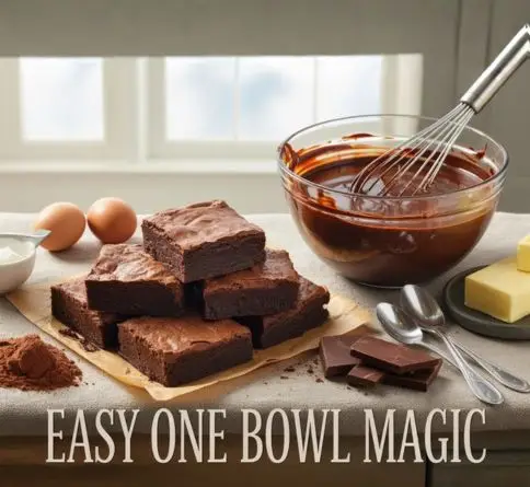 Easy one-bowl chocolate brownies with glossy crackled tops and fudgy centers beside a mixing bowl and baking ingredients.